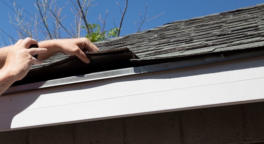 two hands repair roof