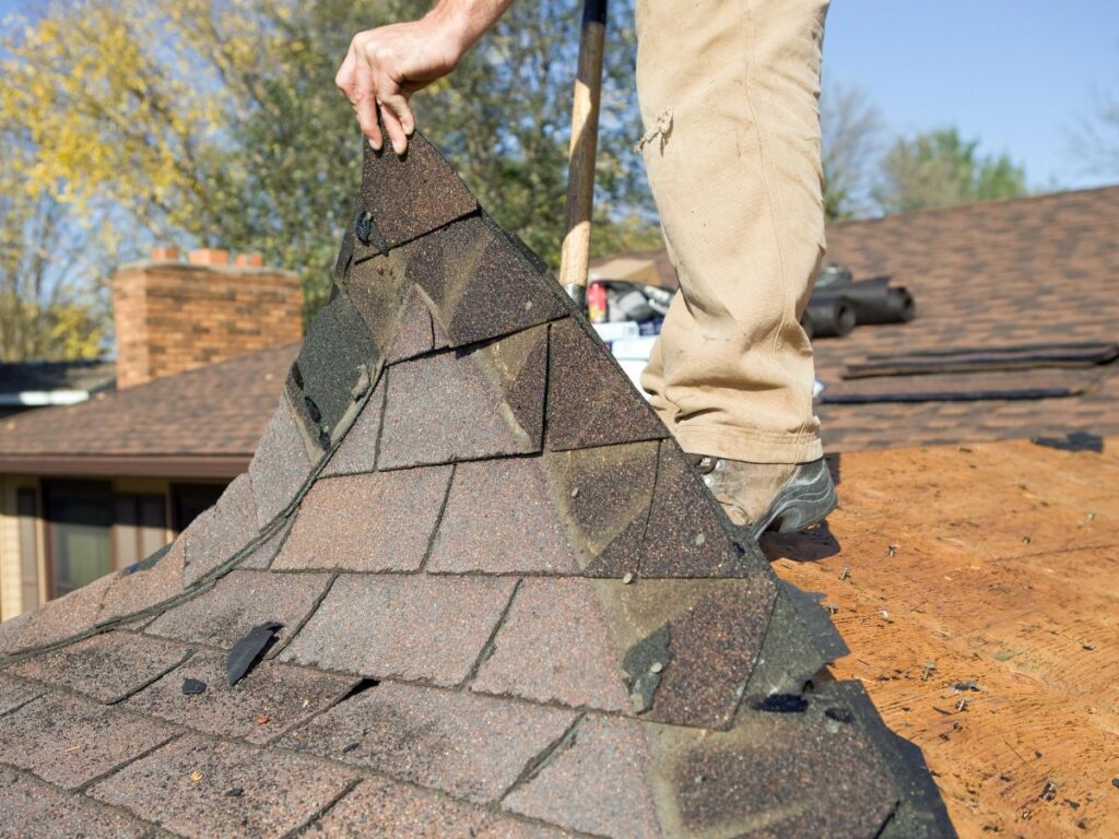 A man removing a roof cover.