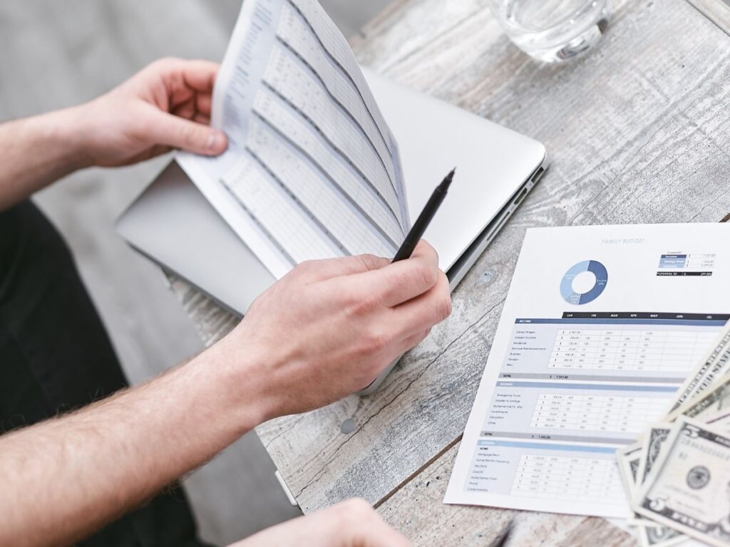 A man holding a paper and a ballpen.