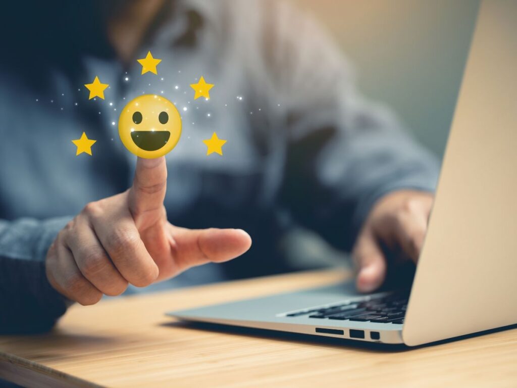 A person touching a glowing emoji icon with stars.