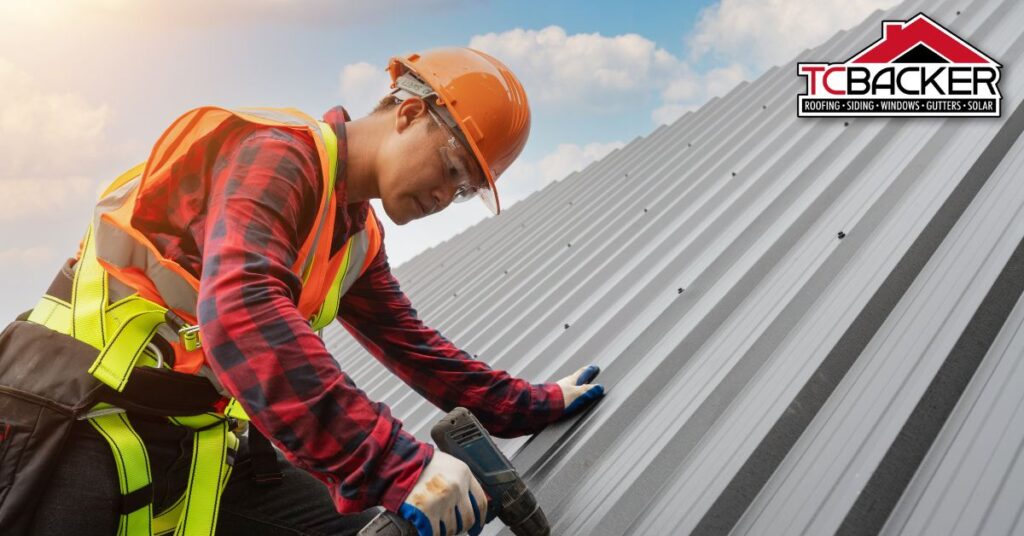 A man wearing an orange hardhat repairing the roof.