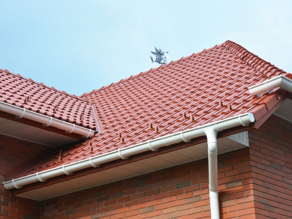 Bright red tiled roof with clean gutters.