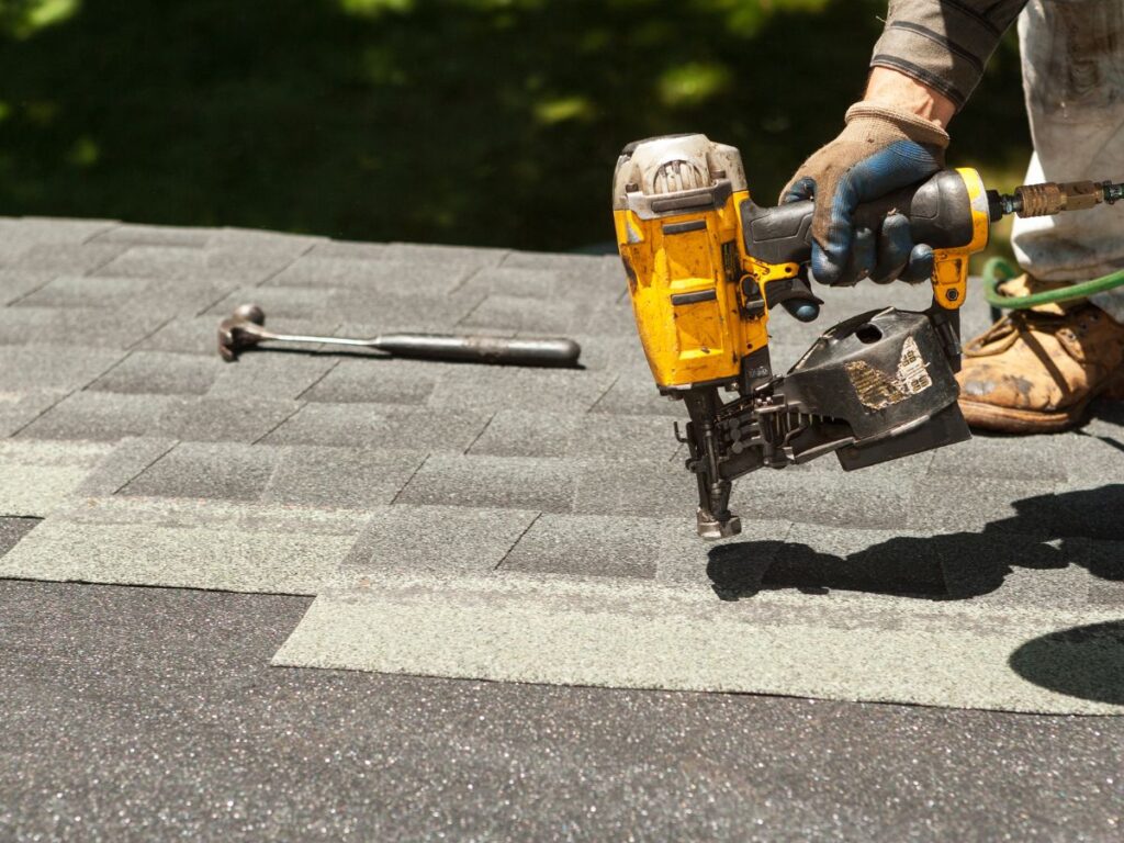 A close up of a driller being used on the roof.