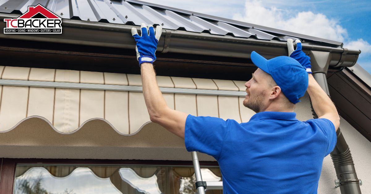 A man installing a new roof gutter.