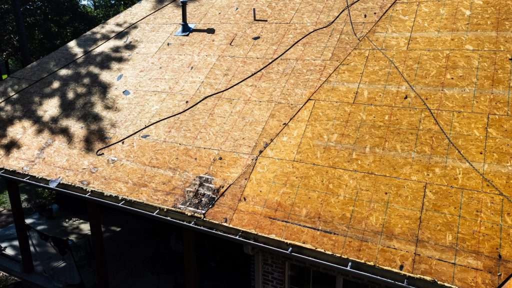 how long does it take to replace a roof Roof of house in process of being replaced with deck boards.
